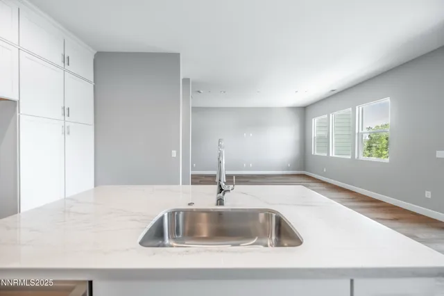 a kitchen with granite countertop a sink and a window