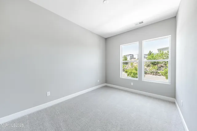 a bathroom with a granite countertop sink a toilet and a mirror