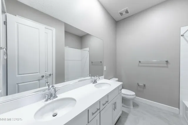 a utility room with a sink a mirror and vanity