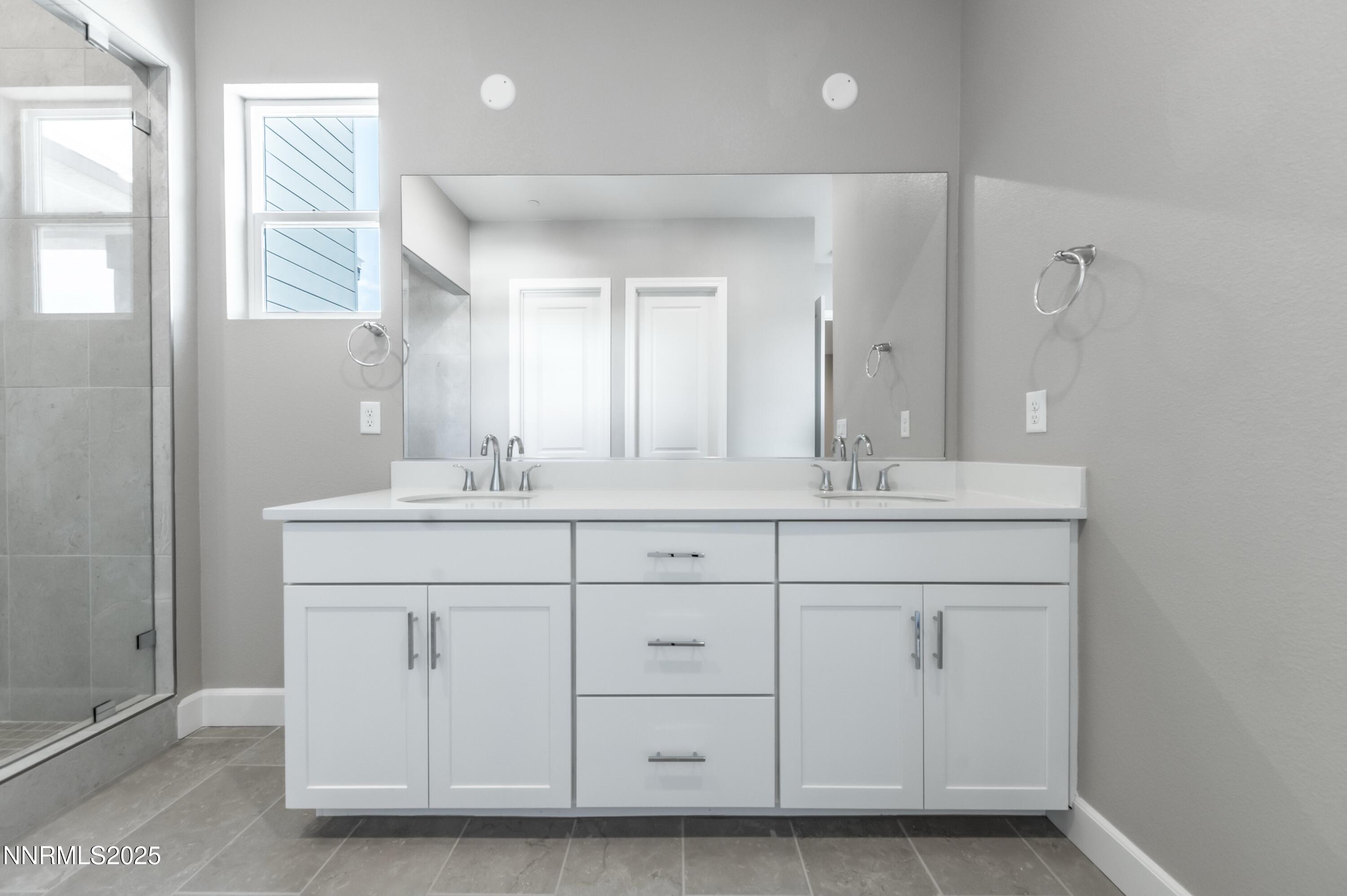 1517 Golf Club Drive Reno, NV 89519 - Photo 36 of 49 a bathroom with a sink and a mirror