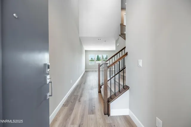 a view of entryway and hall with wooden floor