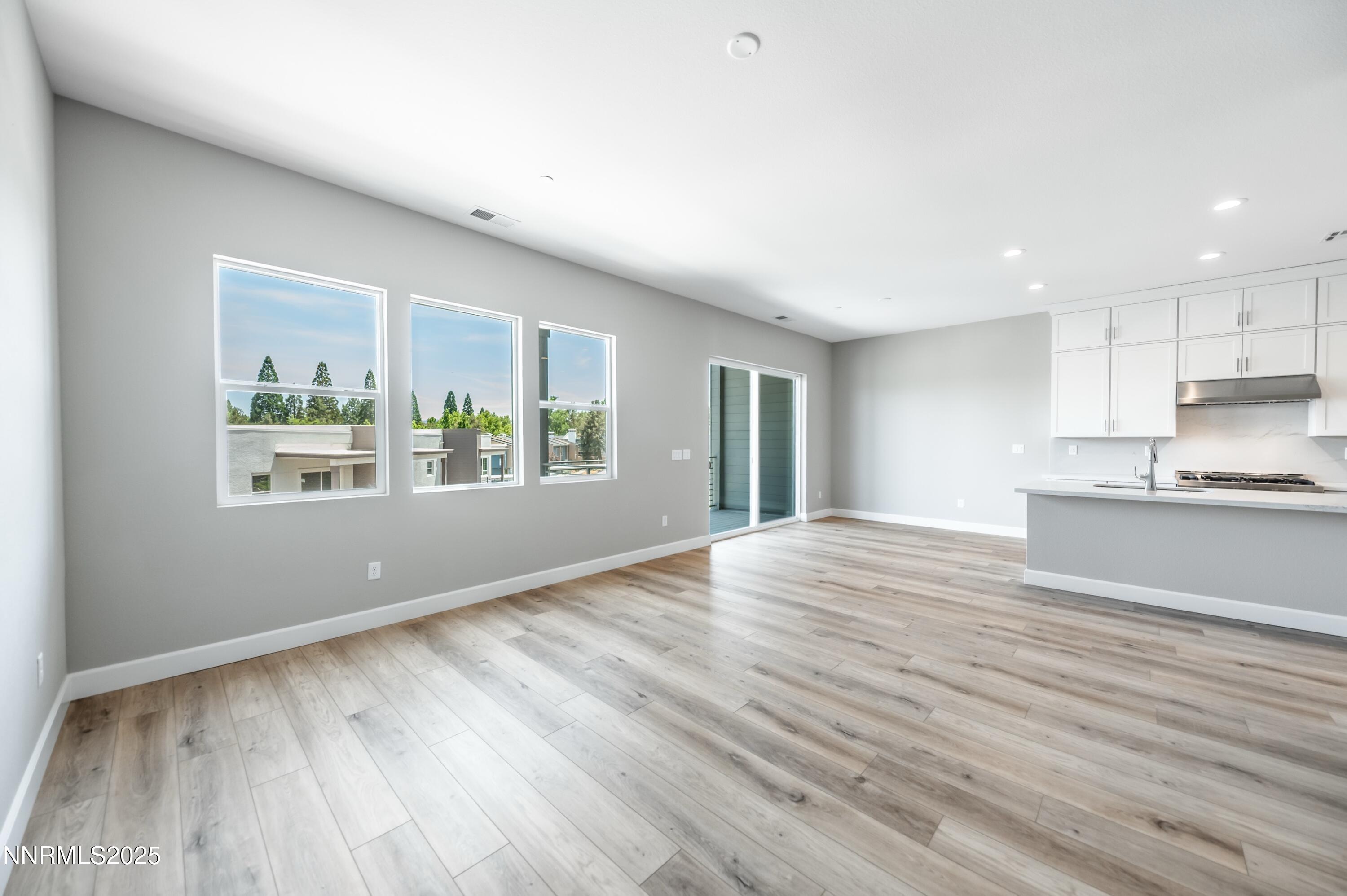 1517 Golf Club Drive Reno, NV 89519 - Photo 7 of 49 a view of an empty room with wooden floor and a window