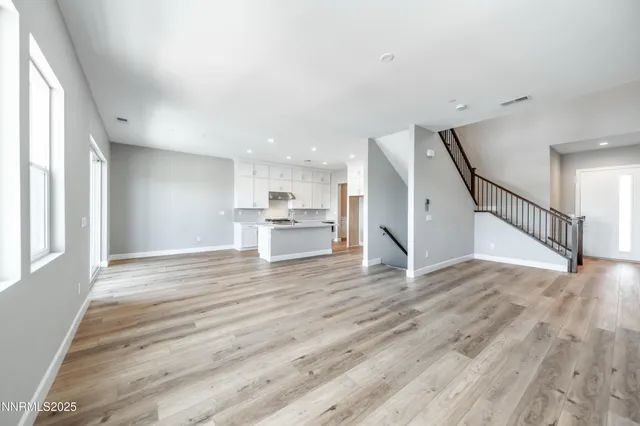 a view of kitchen and hall with wooden floor