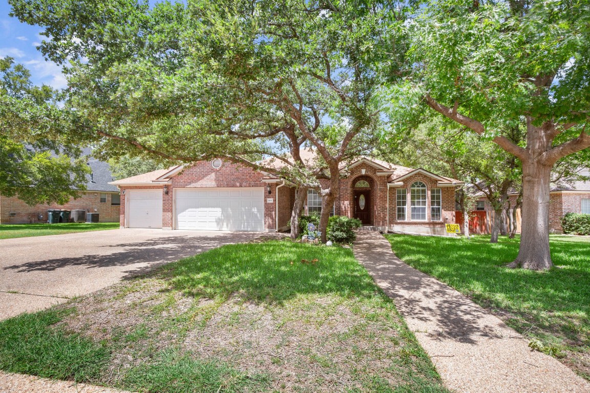900 Hedgewood Drive Georgetown, TX 78628 - Photo 1 of 1 a front view of a house with yard and green space