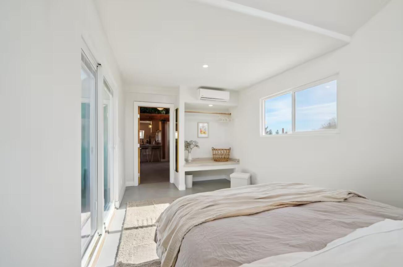 59727 Sharp Terrace Drive Yucca Valley, CA 92284 - Photo 17 of 38 a bedroom with a bed and a view of kitchen