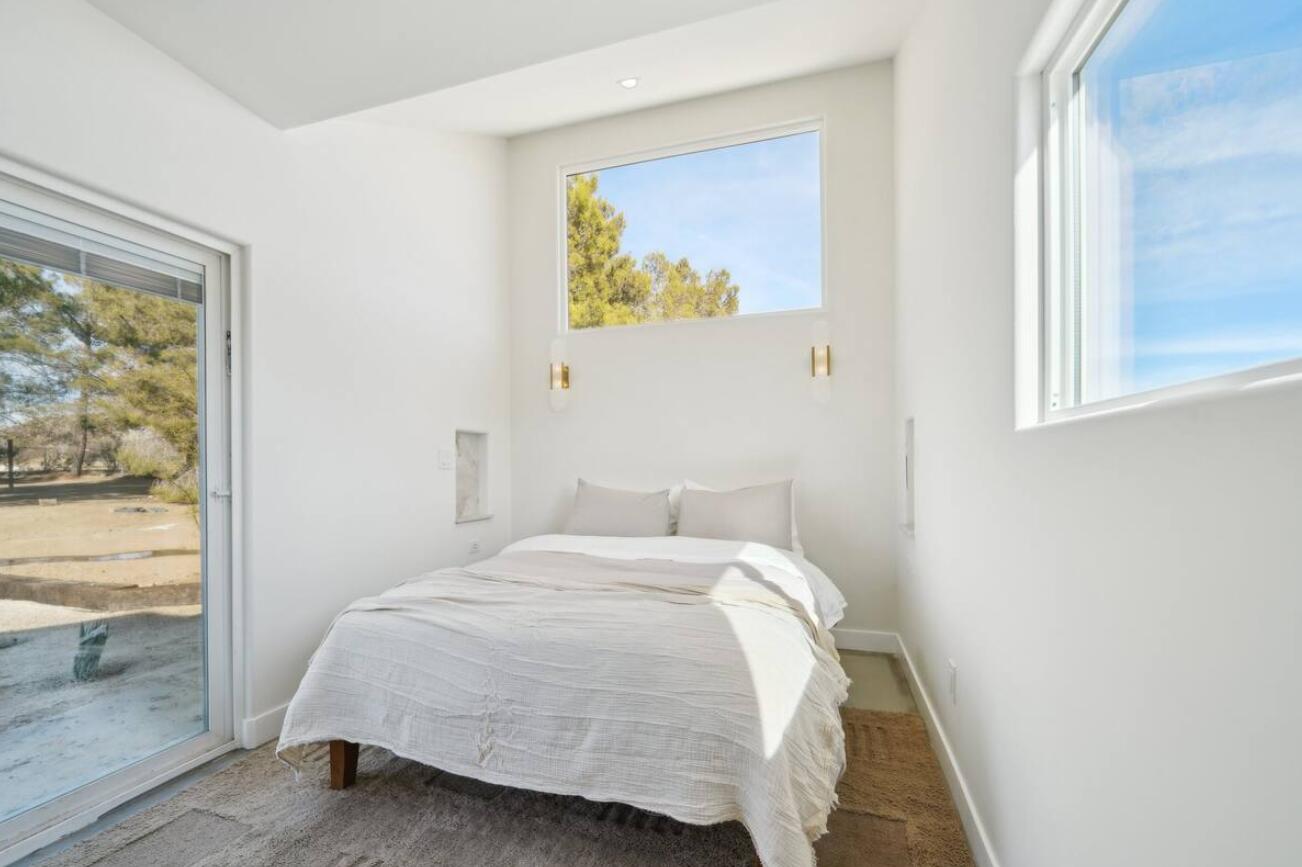 59727 Sharp Terrace Drive Yucca Valley, CA 92284 - Photo 19 of 38 a bedroom with a bed and a window