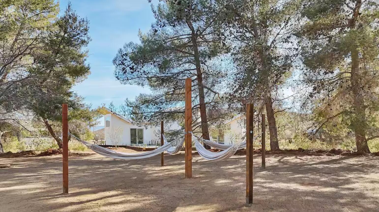 59727 Sharp Terrace Drive Yucca Valley, CA 92284 - Photo 36 of 38 a front view of a house with garden and trees
