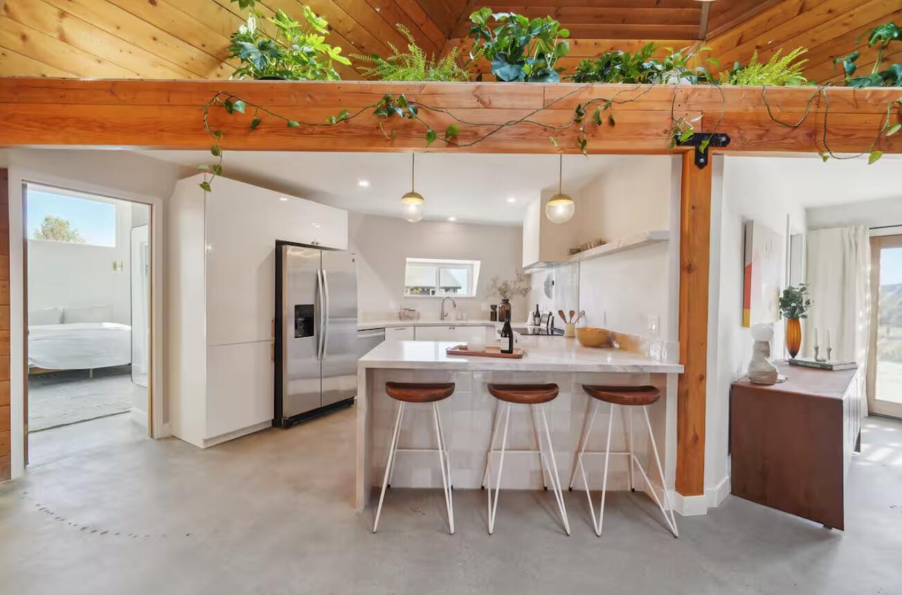 59727 Sharp Terrace Drive Yucca Valley, CA 92284 - Photo 8 of 38 a kitchen with a sink and chairs