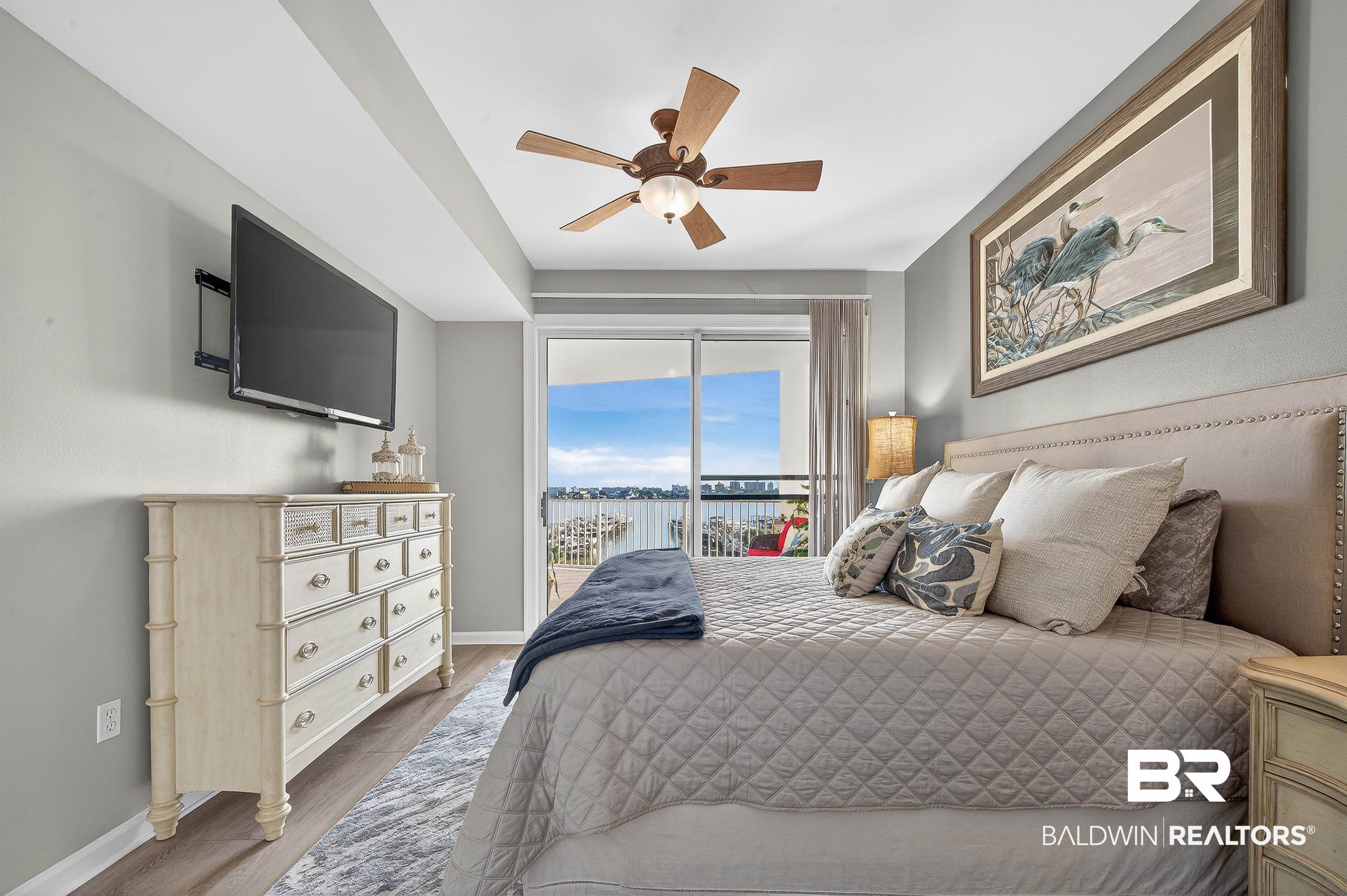 27282 Canal Road, Unit 408 Orange Beach, AL 36561 - Photo 9 of 37 Bedroom featuring access to exterior, wood finished floors, and ceiling fan