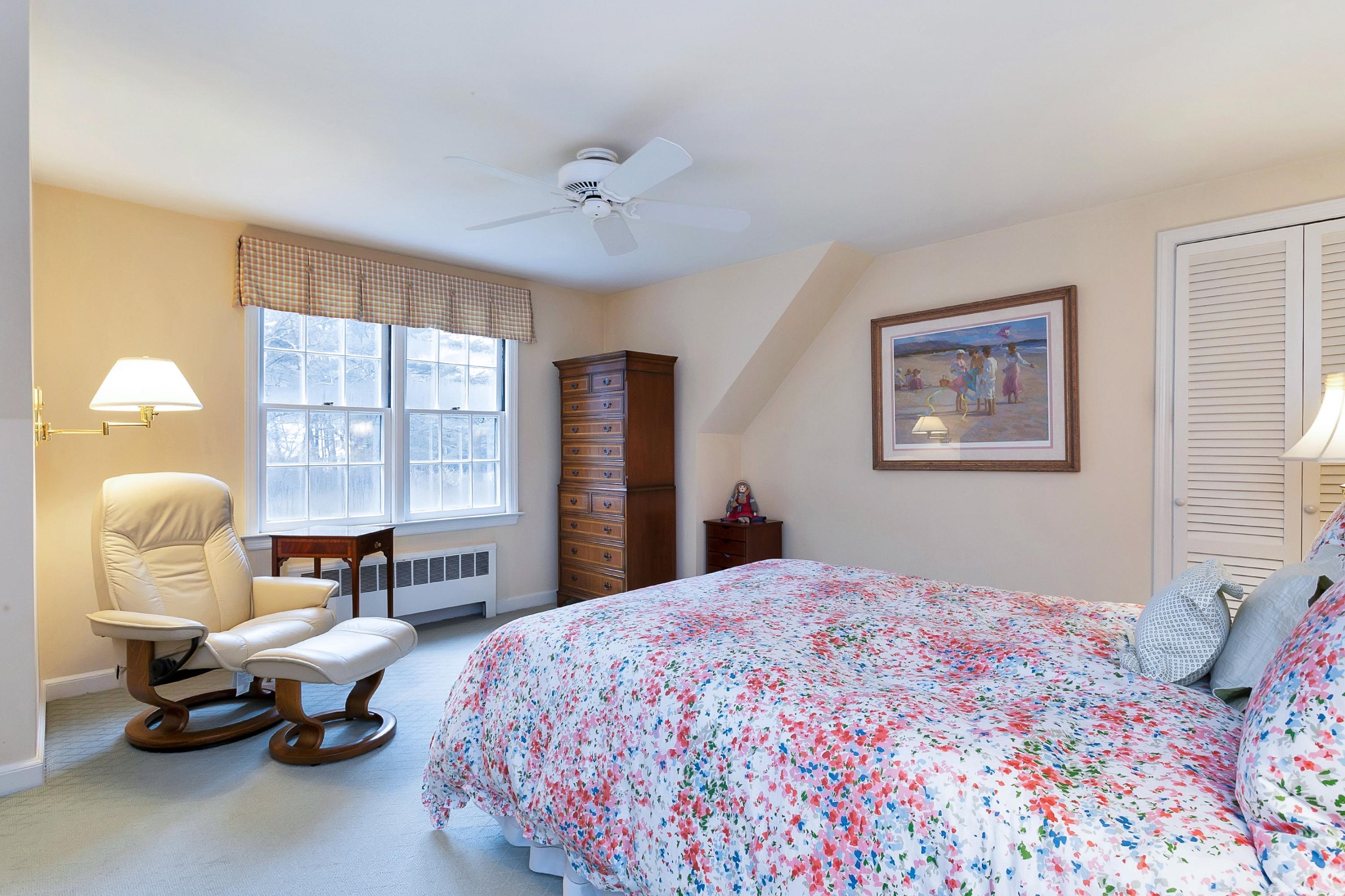 5 Meadow Road Darien, CT 06820 - Photo 16 of 25 a bedroom with a bed and a chandelier
