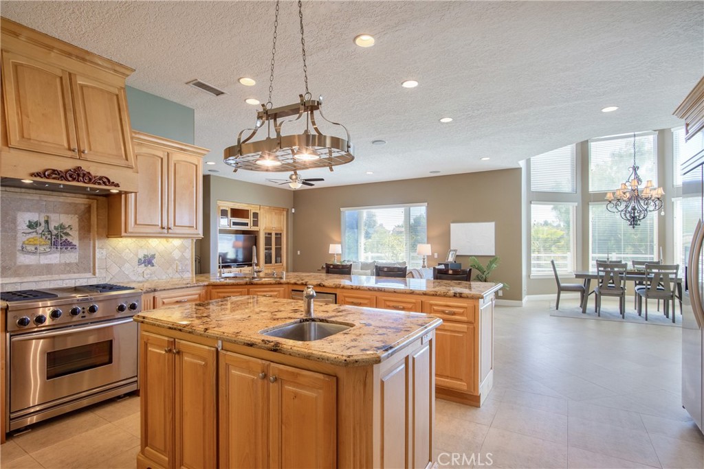 41380 La Sierra Road Temecula, CA 92591 - Photo 17 of 72 a kitchen with stainless steel appliances granite countertop a sink stove and cabinets