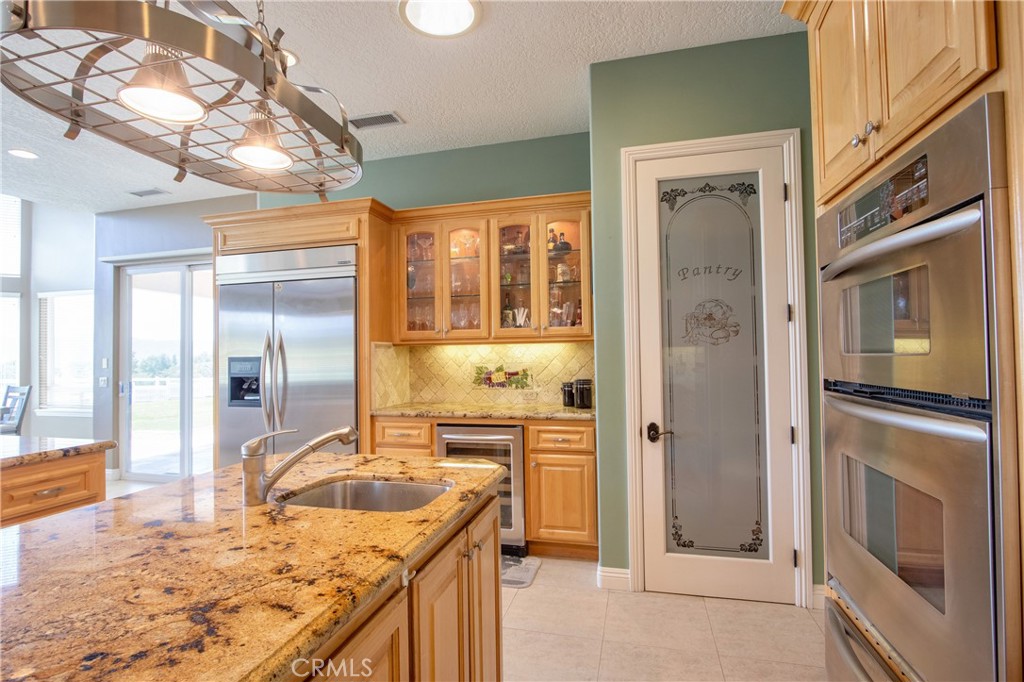 41380 La Sierra Road Temecula, CA 92591 - Photo 20 of 72 a bathroom with a granite countertop sink and a mirror