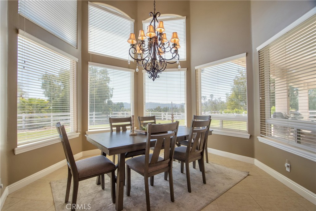 41380 La Sierra Road Temecula, CA 92591 - Photo 21 of 72 a view of a dining room with furniture large windows and wooden floor