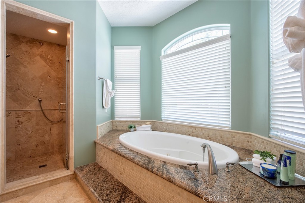 41380 La Sierra Road Temecula, CA 92591 - Photo 28 of 72 a bathroom with a granite countertop tub and a sink