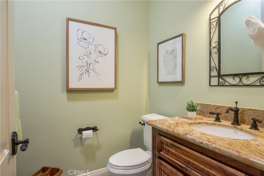 41380 La Sierra Road Temecula, CA 92591 - Photo 30 of 72 a bathroom with a granite countertop toilet sink and mirror