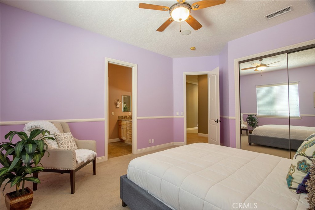 41380 La Sierra Road Temecula, CA 92591 - Photo 32 of 72 a bedroom with a bed and a chandelier