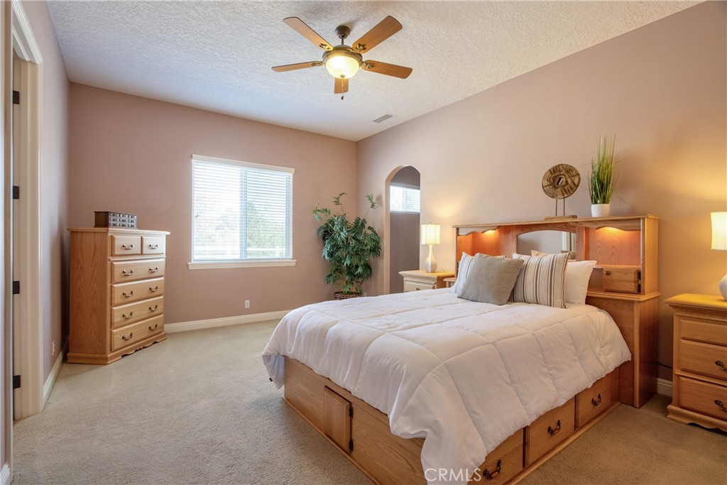 41380 La Sierra Road Temecula, CA 92591 - Photo 35 of 72 a bedroom with a bed and a chandelier
