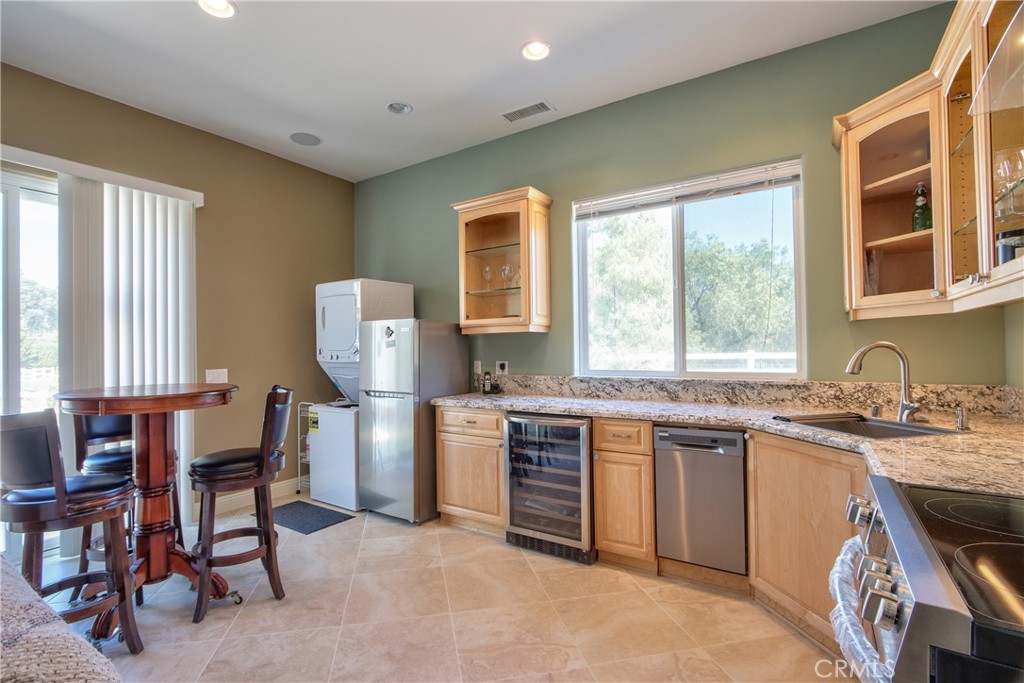 41380 La Sierra Road Temecula, CA 92591 - Photo 40 of 72 a kitchen with stainless steel appliances granite countertop a stove a sink and a refrigerator