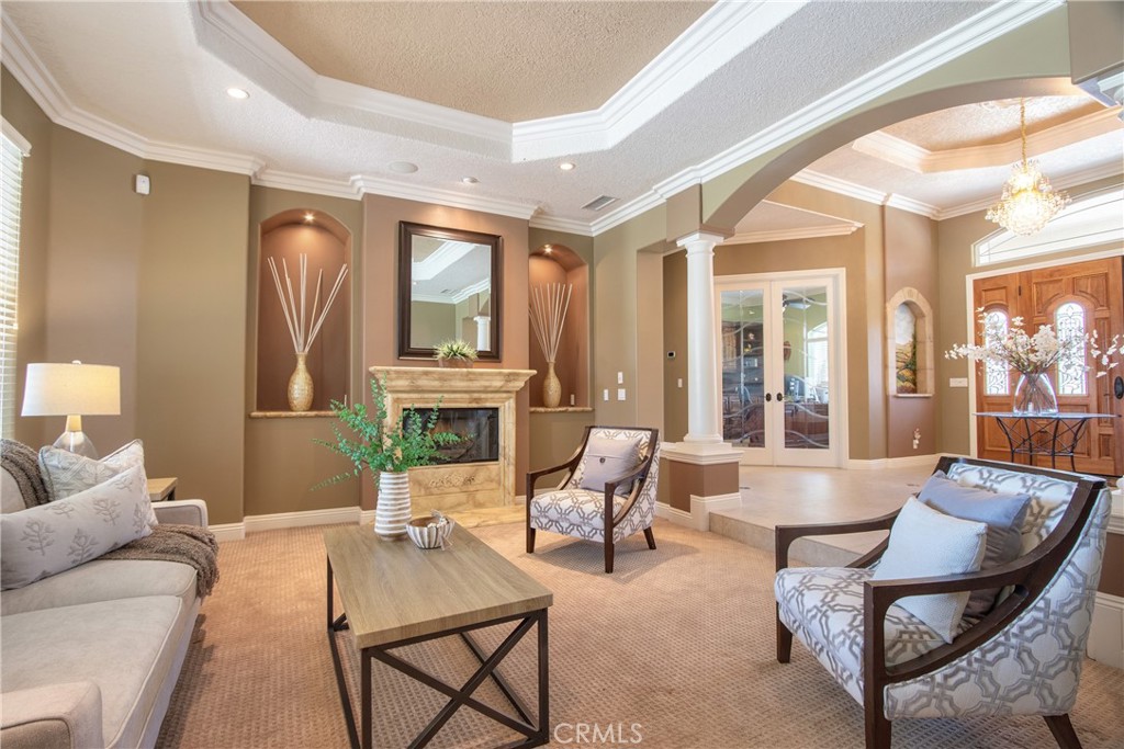 41380 La Sierra Road Temecula, CA 92591 - Photo 7 of 72 a living room with furniture a fireplace and a large window