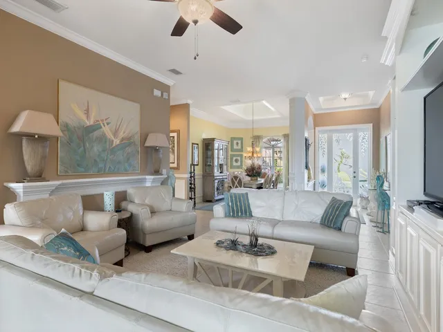 a view of a dining room with furniture a chandelier and wooden floor