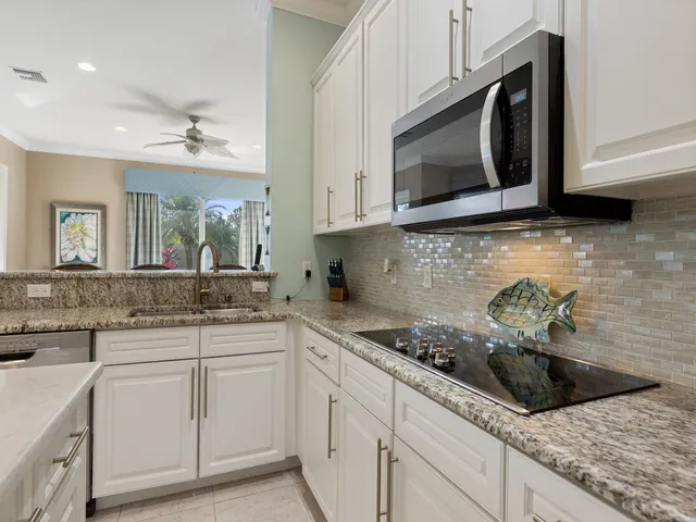 a kitchen with cabinets appliances a sink and a counter top space