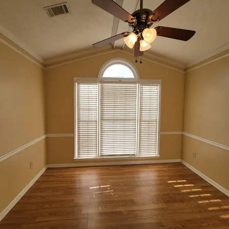 a room with a table chairs and a wooden floor
