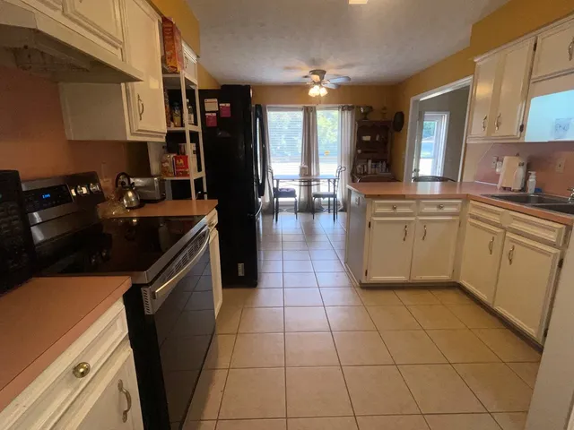 a kitchen with cabinets and appliances