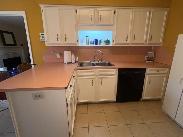 a kitchen with a stove top oven and cabinets