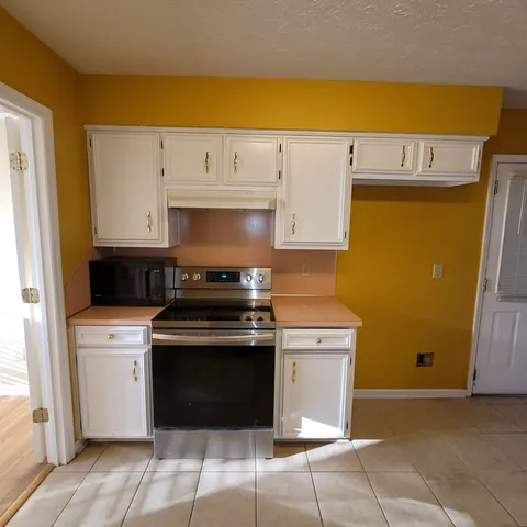 a kitchen with a stove and a refrigerator
