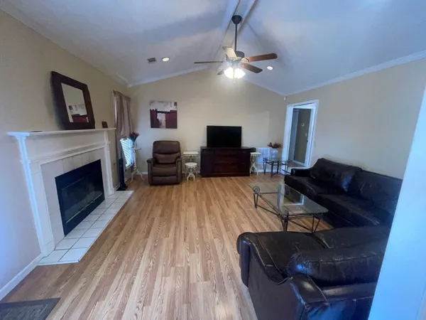 a living room with furniture and a fireplace
