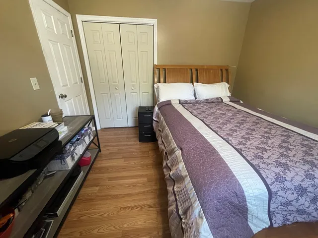 a bedroom with a bed and window