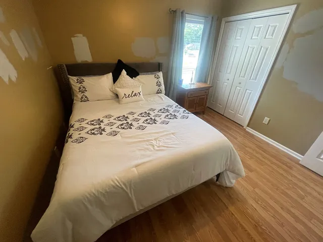 a living room with furniture a ceiling fan and a window