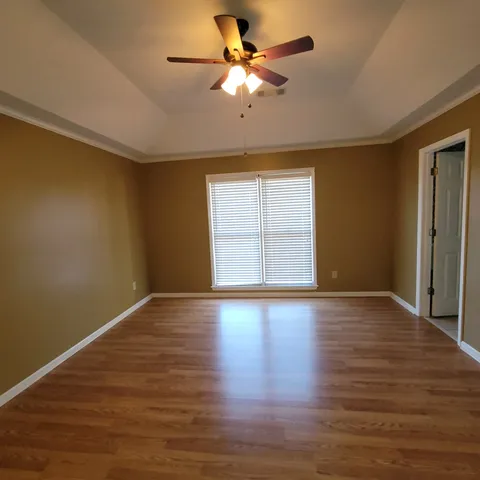 a view of a room with wooden floor and white walls