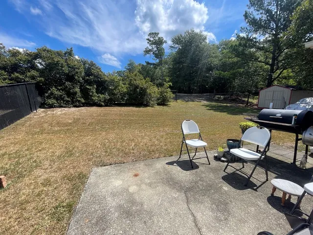 a swimming pool with outdoor seating and trees