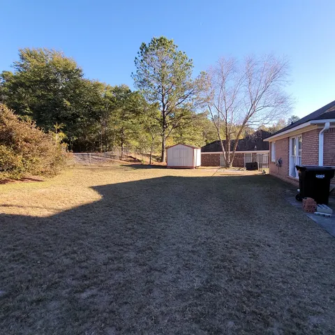 a view of a yard with a house and trees