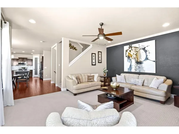 a living room with furniture and kitchen view