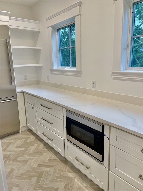 27 Bold Meadow Road Edgartown, MA 02539 - Photo 11 of 40 a kitchen with white cabinets and window