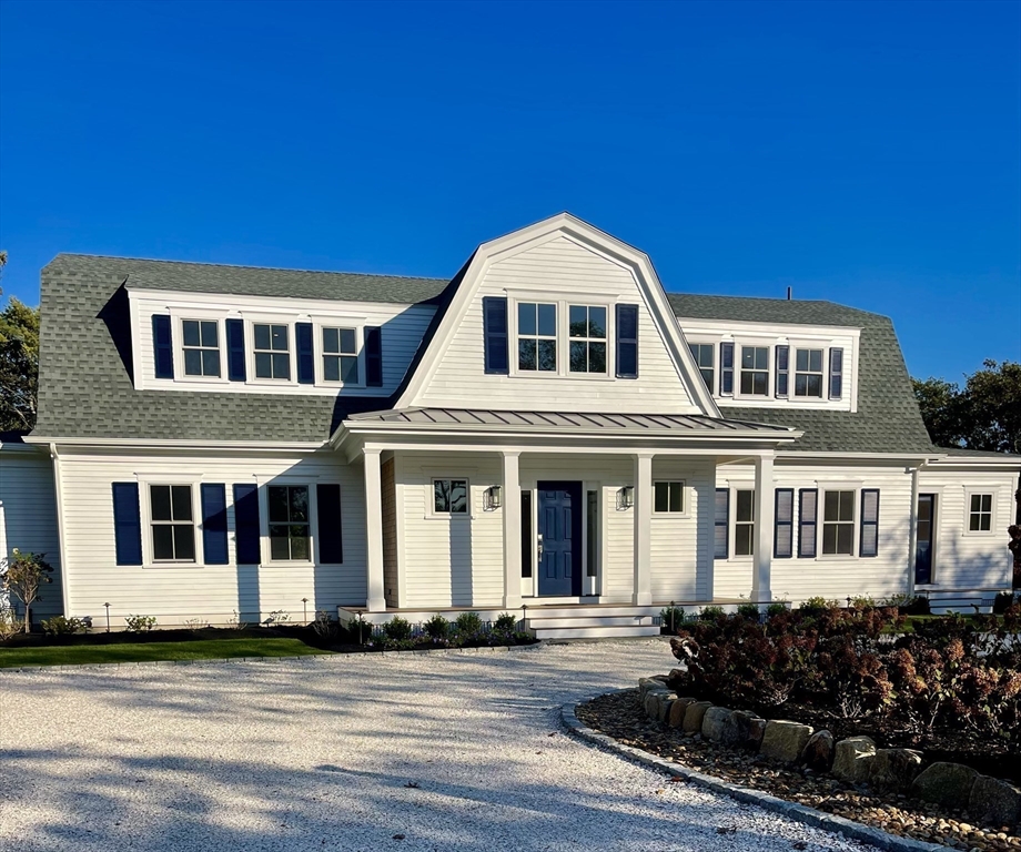 27 Bold Meadow Road Edgartown, MA 02539 - Photo 2 of 40 a front view of a house with a yard