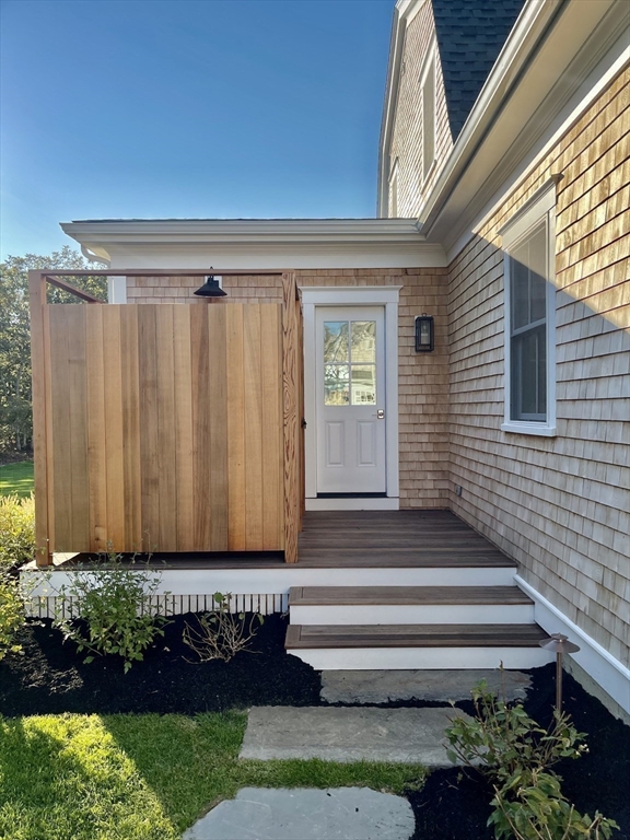 27 Bold Meadow Road Edgartown, MA 02539 - Photo 26 of 40 a front view of a house with a garden