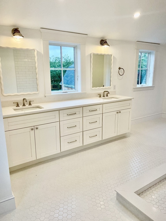 27 Bold Meadow Road Edgartown, MA 02539 - Photo 32 of 40 a spacious bathroom with a granite countertop sink and a mirror