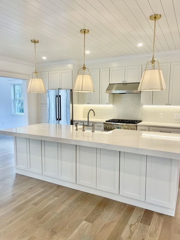 27 Bold Meadow Road Edgartown, MA 02539 - Photo 6 of 40 a kitchen with kitchen island granite countertop a sink a counter space appliances and cabinets