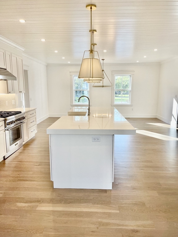 27 Bold Meadow Road Edgartown, MA 02539 - Photo 7 of 40 a kitchen with kitchen island a sink wooden floor and a counter top space