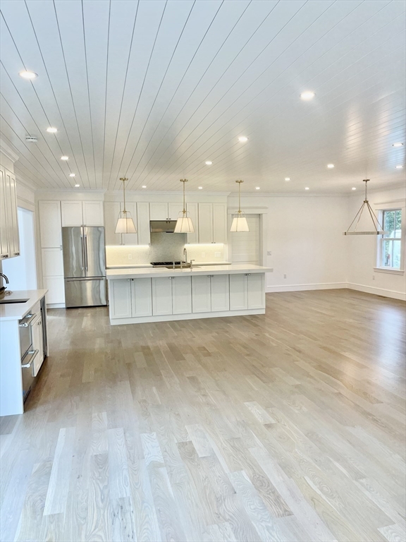 27 Bold Meadow Road Edgartown, MA 02539 - Photo 8 of 40 a large kitchen with stainless steel appliances granite countertop a large counter top a stove a sink dishwasher and a refrigerator with wooden floor