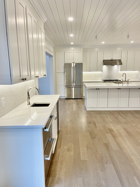 27 Bold Meadow Road Edgartown, MA 02539 - Photo 9 of 40 a kitchen with stainless steel appliances granite countertop a sink a stove and a refrigerator