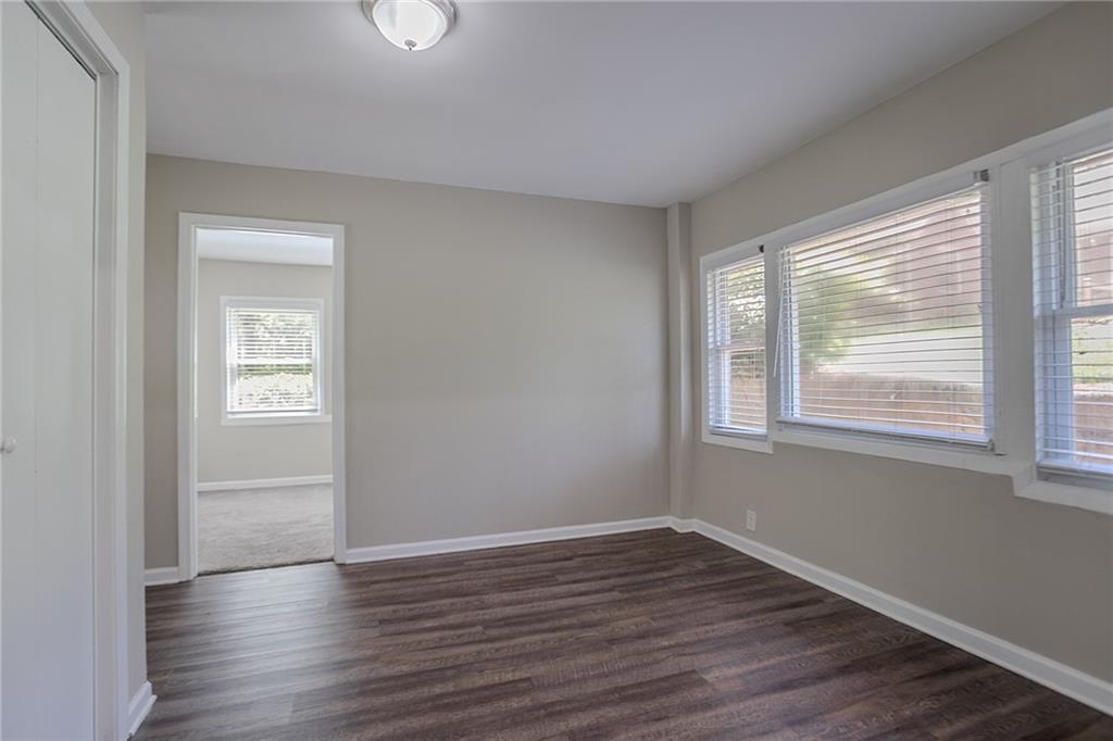 2755 Rockcliff Road Southeast Atlanta, GA 30316 - Photo 16 of 37 a view of an empty room with wooden floor and a window