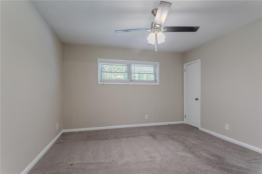2755 Rockcliff Road Southeast Atlanta, GA 30316 - Photo 23 of 37 an empty room with a chandelier fan