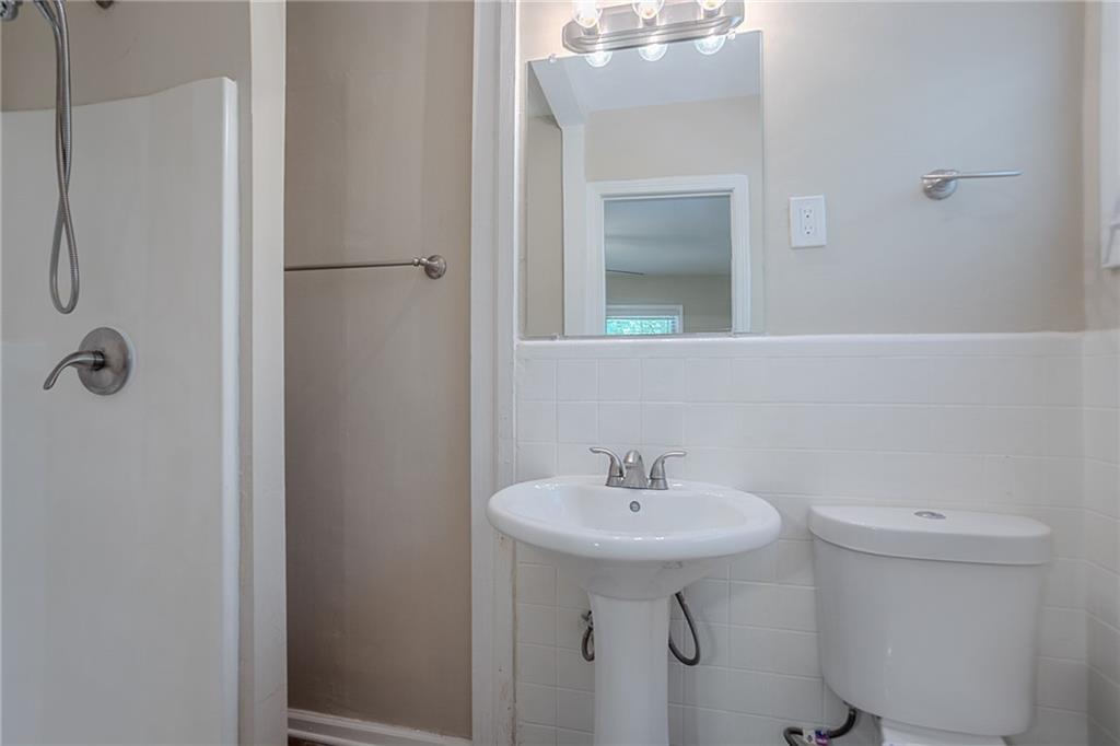 2755 Rockcliff Road Southeast Atlanta, GA 30316 - Photo 25 of 37 a bathroom with a sink a toilet and mirror