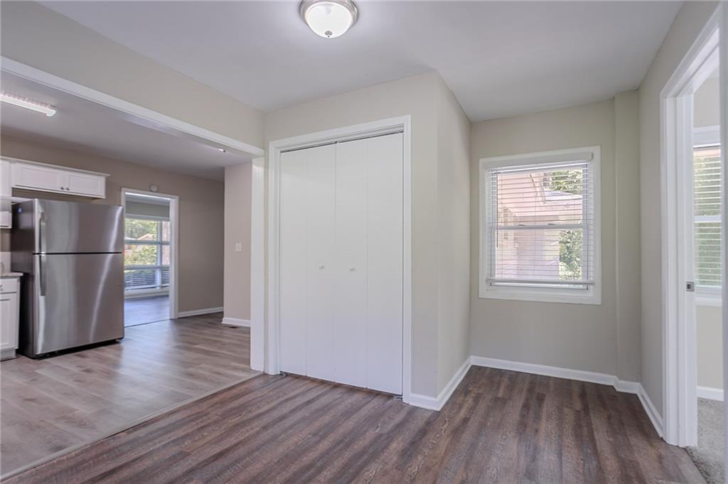 2755 Rockcliff Road Southeast Atlanta, GA 30316 - Photo 6 of 37 an empty room with wooden floor and a window