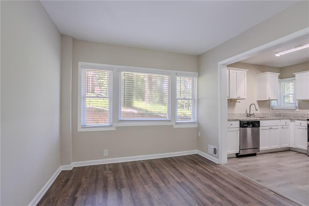 2755 Rockcliff Road Southeast Atlanta, GA 30316 - Photo 7 of 37 an empty room with wooden floor and windows
