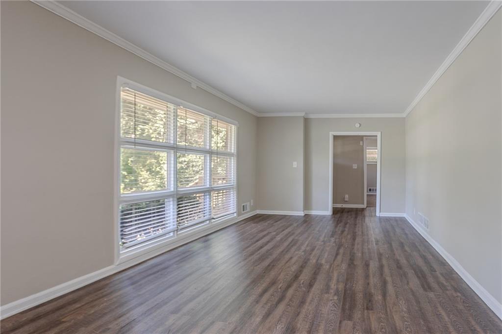 2755 Rockcliff Road Southeast Atlanta, GA 30316 - Photo 9 of 37 an empty room with wooden floor and windows